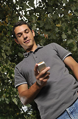 Image showing young casual man talking on cellphone