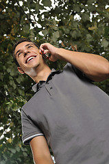 Image showing young casual man talking on cellphone