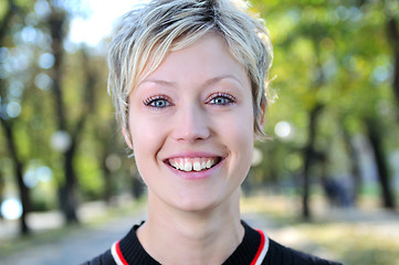 Image showing blonde Cute young woman smiling outdoors