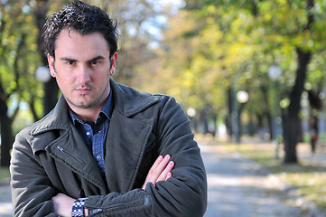 Image showing happy young casual man outdoor portrait posing