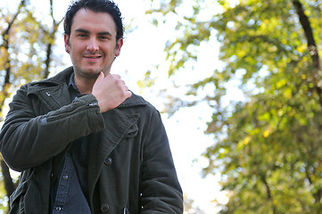 Image showing happy young casual man outdoor portrait posing