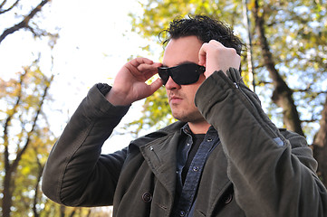 Image showing happy young casual man outdoor portrait posing