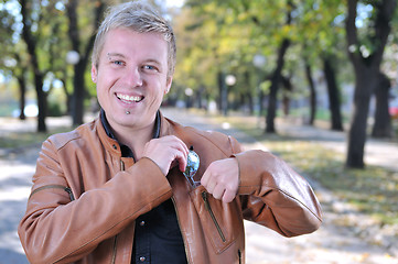 Image showing Handsome young man smiling outdoors