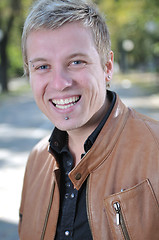 Image showing Handsome young man smiling outdoors