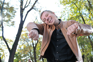 Image showing Handsome young man expressing his inner feeling outside in natur