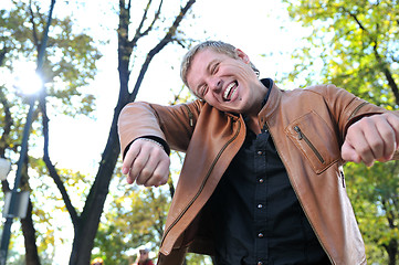 Image showing happy young casual man outdoor portrait posing