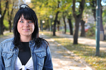 Image showing brunette Cute young woman posing outdoors