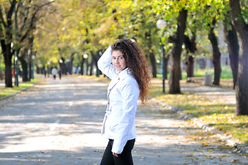 Image showing brunette Cute young woman smiling outdoors in nature