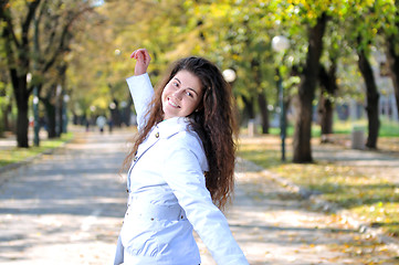 Image showing brunette Cute young woman smiling outdoors in nature