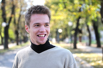 Image showing Handsome young man smiling outdoors