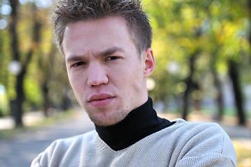 Image showing happy young casual man outdoor portrait posing