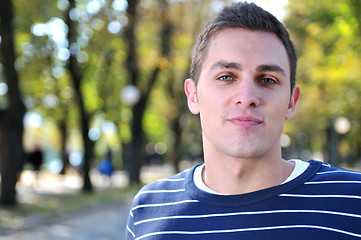 Image showing happy young casual man outdoor portrait posing