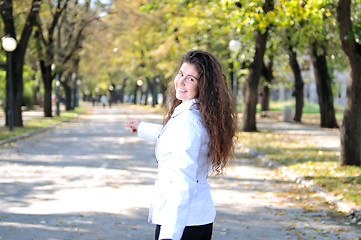 Image showing brunette Cute young woman smiling outdoors in nature