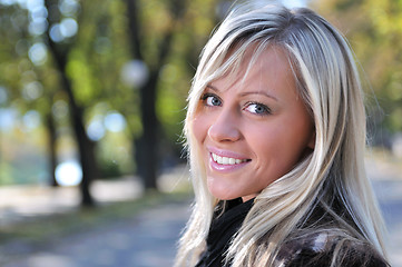 Image showing blonde Cute young woman smiling outdoors