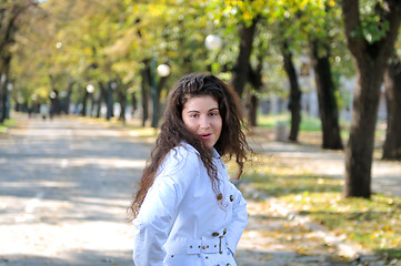 Image showing brunette Cute young woman smiling outdoors in nature