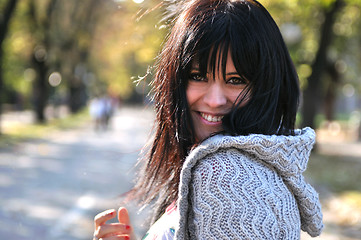 Image showing brunette Cute young woman smiling outdoors