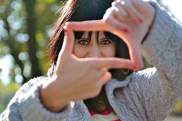 Image showing Young woman pretending to see throuhg a  lens