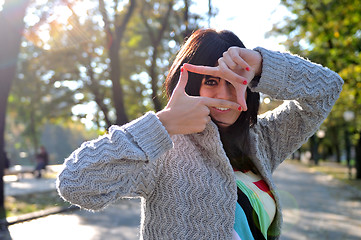 Image showing brunette Cute young woman  posing outdoors