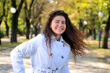 Image showing brunette Cute young woman smiling outdoors in nature