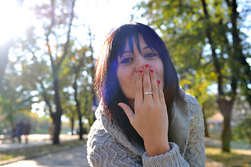 Image showing brunette Cute young woman  posing outdoors