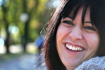 Image showing brunette Cute young woman smiling outdoors