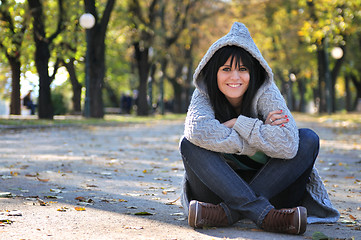 Image showing Cute young woman smiling outdoors in nature