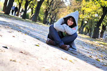 Image showing Cute young woman smiling outdoors in nature