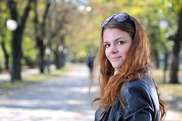 Image showing brunette Cute young woman posing outdoors