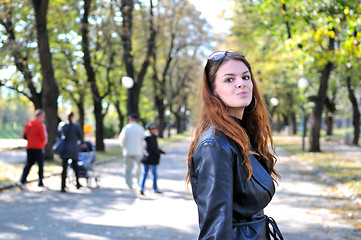 Image showing brunette Cute young woman posing outdoors