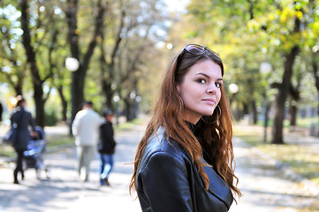 Image showing brunette Cute young woman posing outdoors