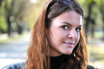 Image showing brunette Cute young woman posing outdoors