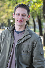 Image showing Handsome young man smiling outdoors