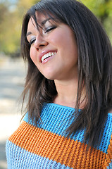 Image showing brunette Cute young woman smiling outdoors in nature