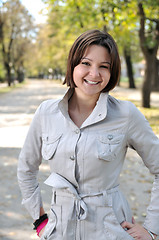 Image showing brunette Cute young woman smiling outdoors in nature