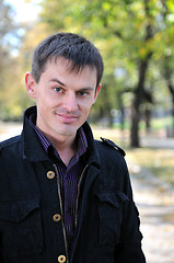 Image showing happy young casual man outdoor portrait posing