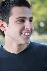 Image showing Handsome young man smiling outdoors