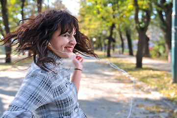 Image showing brunette Cute young woman  dancing outdoors