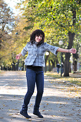 Image showing brunette Cute young woman  dancing outdoors