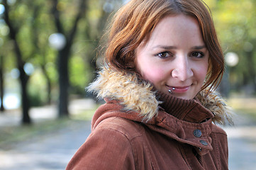 Image showing brunette Cute young woman with piercing posing outdoors