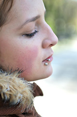 Image showing brunette Cute young woman with piercing posing outdoors