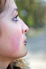 Image showing brunette Cute young woman with piercing posing outdoors