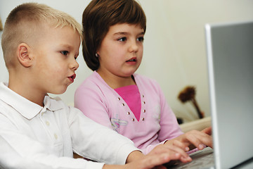 Image showing childrens have fun and playing games on laptop computer