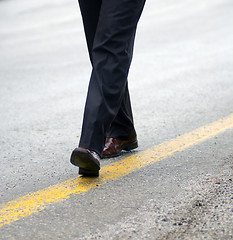 Image showing .businessman walking on yellow line