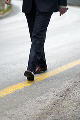 Image showing .businessman walking on yellow line