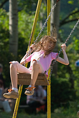 Image showing happy girl swinging 