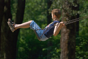 Image showing boy swinging in park