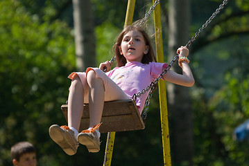 Image showing happy girl swinging 