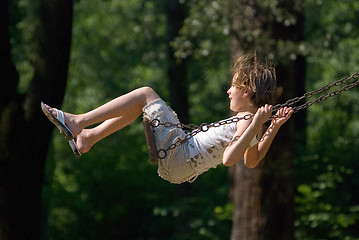 Image showing happy girl swinging 