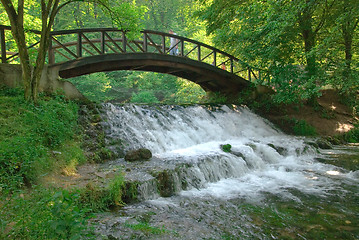 Image showing wooden bring over small waterfall 