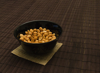 Image showing peanuts in black can